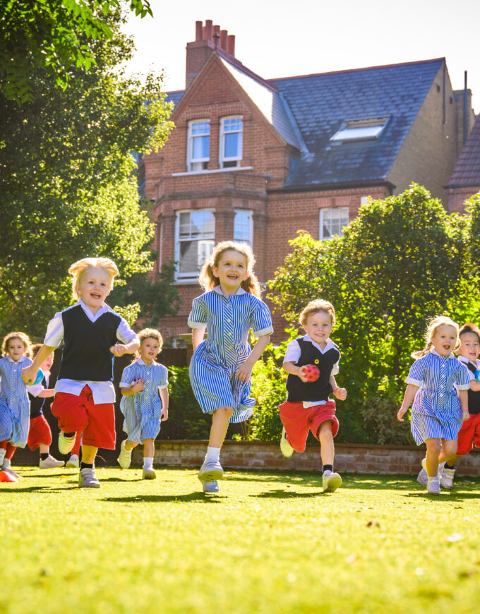 little students running across the lawn