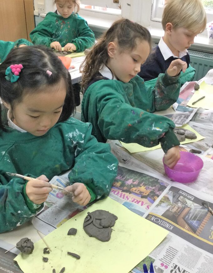students working with clay