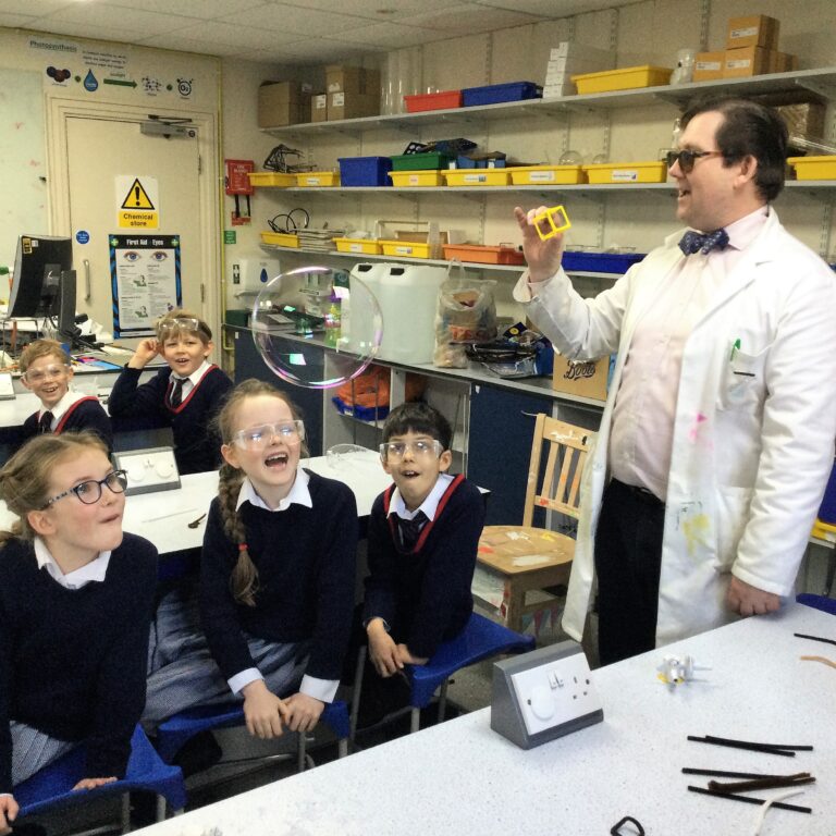 students watching a bubble float