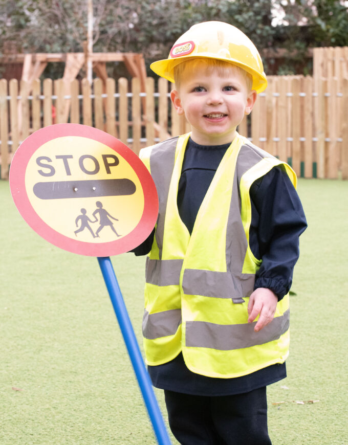 boy holding a stop sign