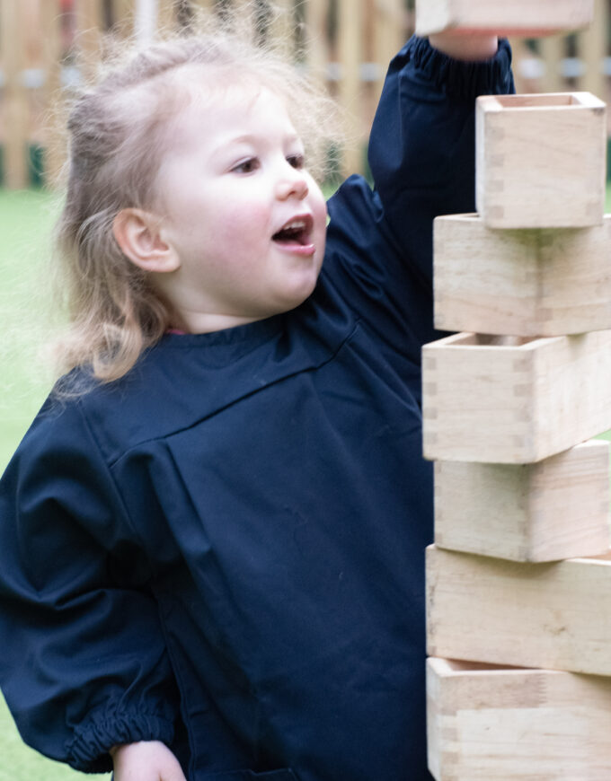 girl stacking boxes