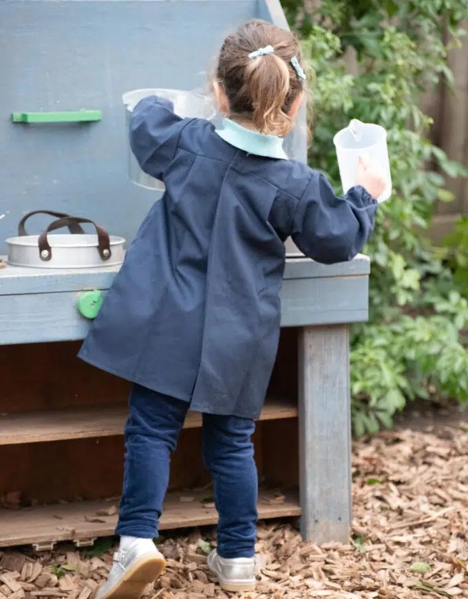 girl using a mud kitchen