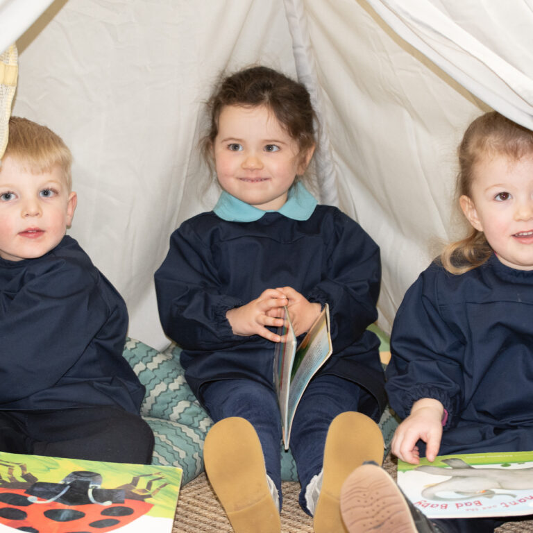 students reading under a fort