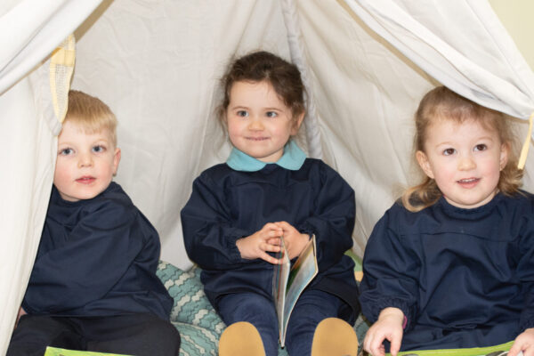 students reading under a fort