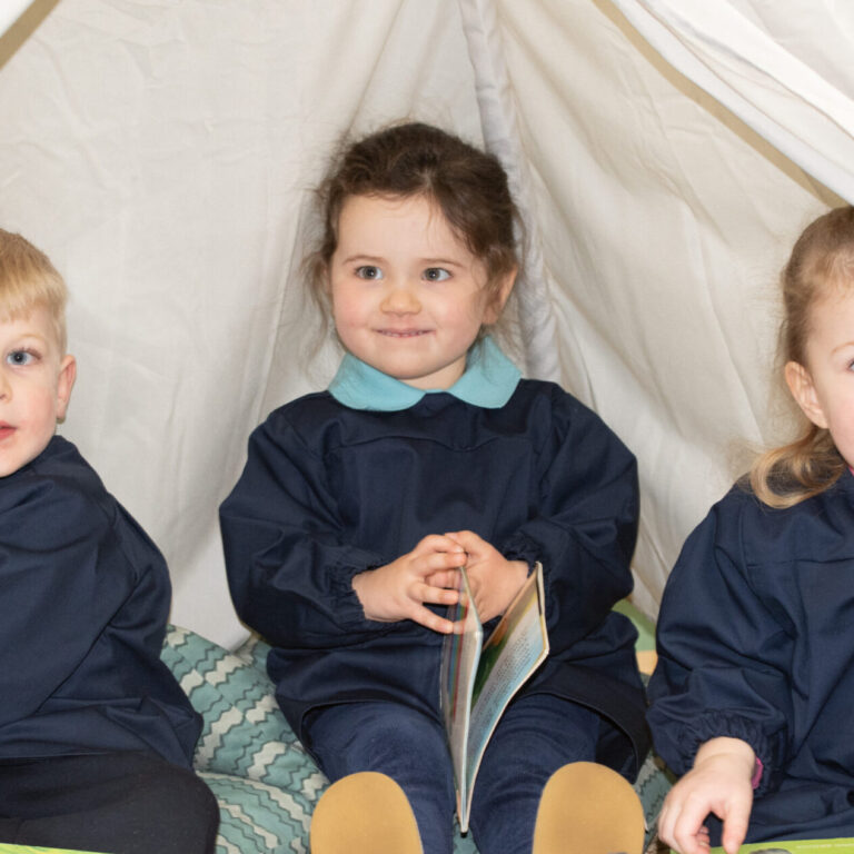 students reading under a fort