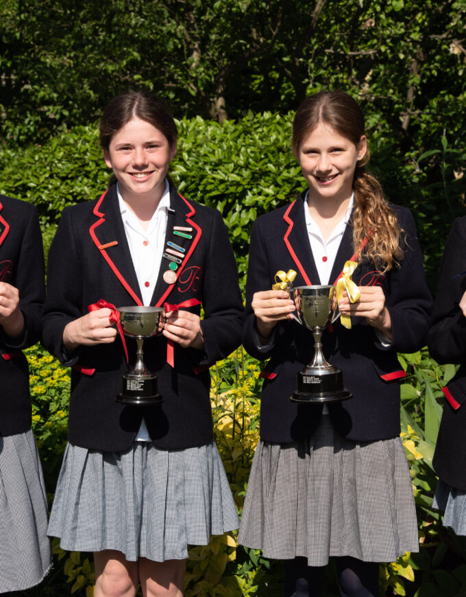 students holding trophies