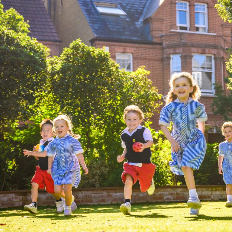 young children running across the astroturf