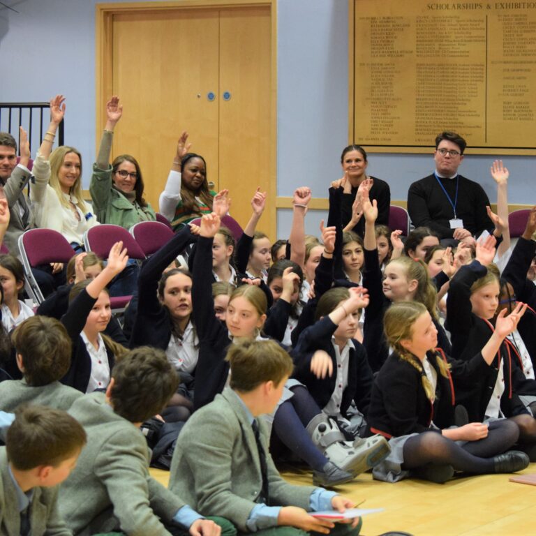 students raising their hands