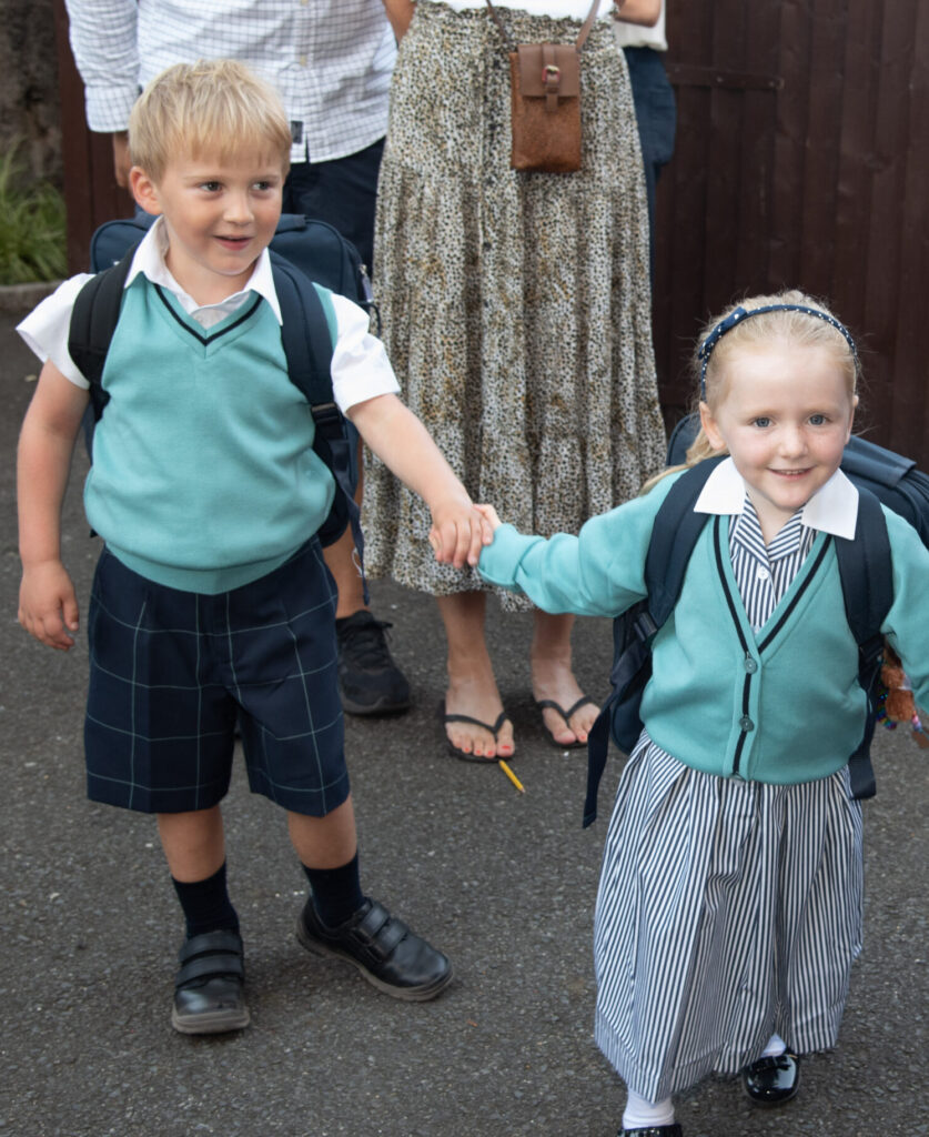 2 students holding hands