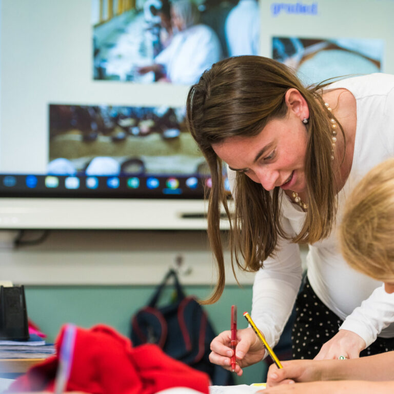 teacher helping a child in class