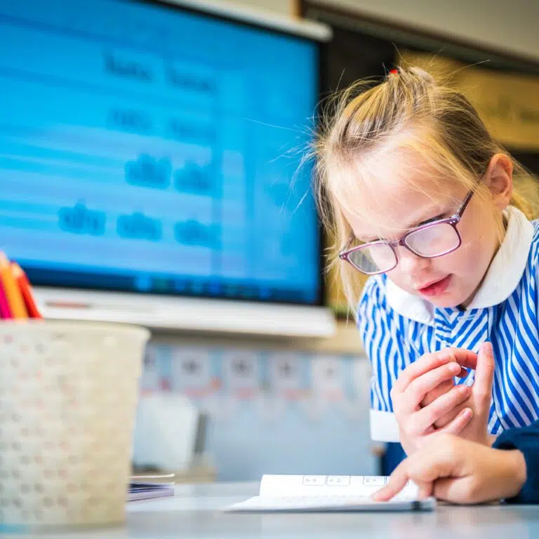 girl looking at her workbook